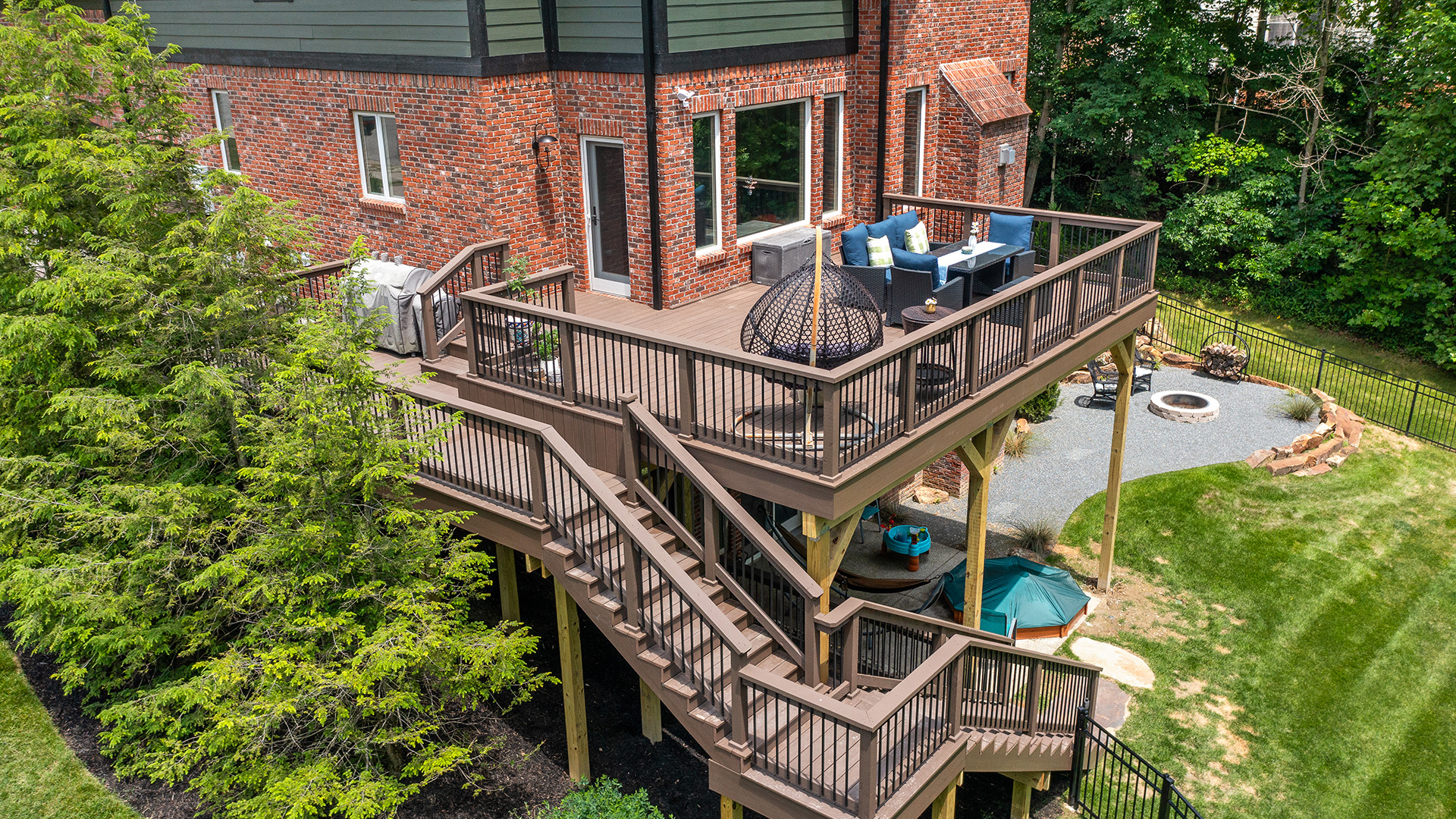 multi-level backyard deck construction with stairs and outdoor seating area by Gannon and Company